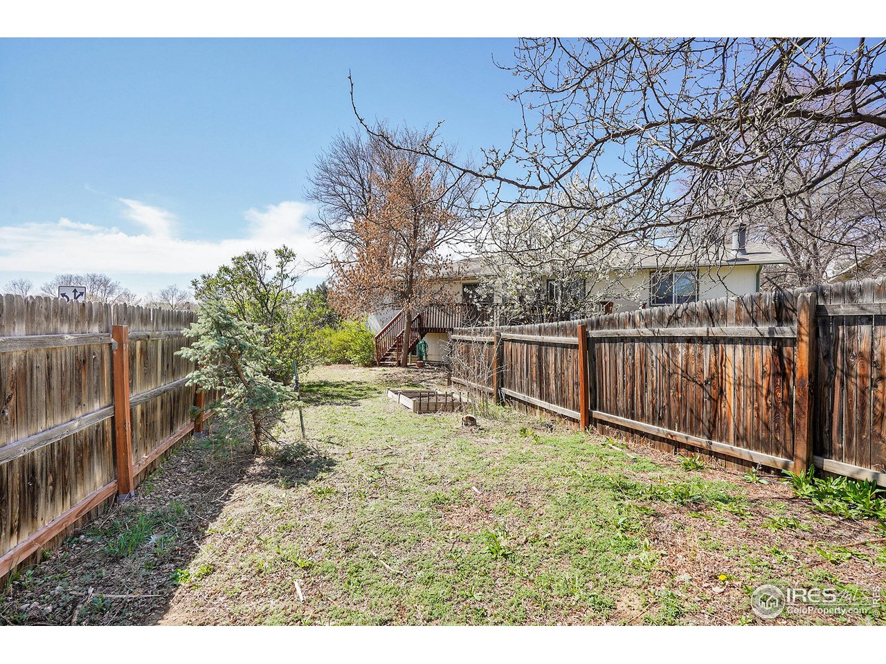 1209 Centaur Circle, Unit B Lafayette, CO 80026 - Photo 27 of 36 a view of a backyard with wooden fence and a bench