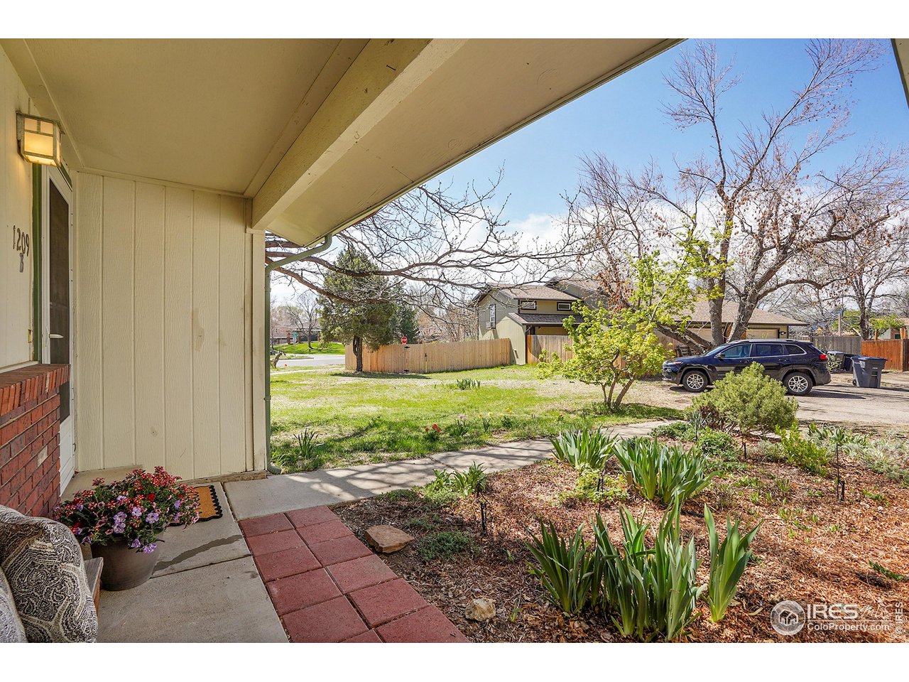 1209 Centaur Circle, Unit B Lafayette, CO 80026 - Photo 3 of 36 a view of a house with a big yard and large tree