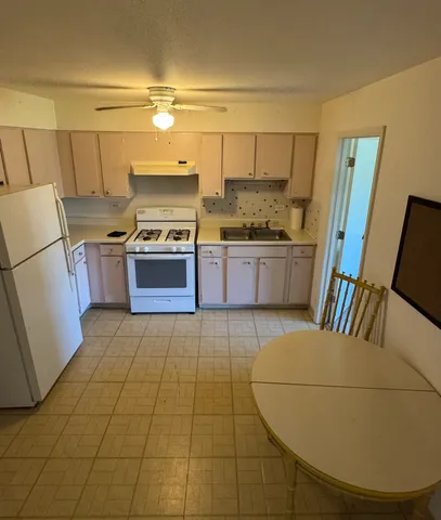 a kitchen with a sink a stove and refrigerator