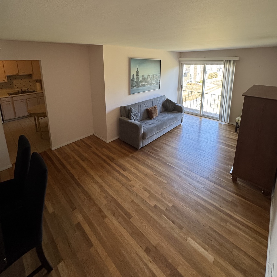 8804 Golf Road, Unit 2F Des Plaines, IL 60016 - Photo 4 of 8 a spacious bedroom with a bed and wooden floor