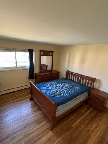 a bed sitting in a bedroom next to a window