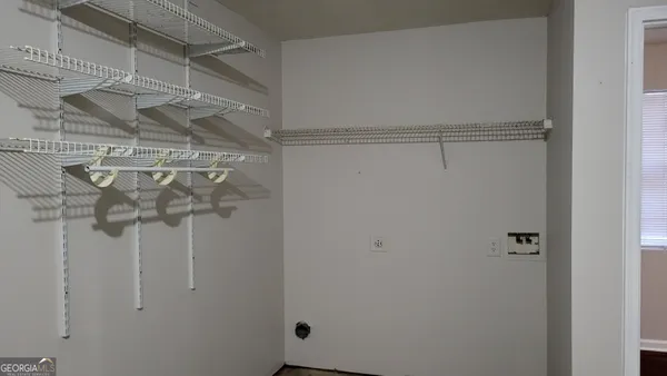 an empty room with a chandelier fan