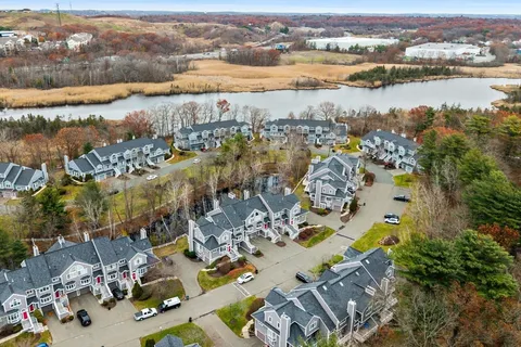 an aerial view of lake and residential houses with outdoor space
