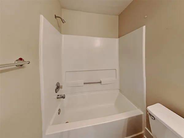 a bathroom with a bathtub and a toilet