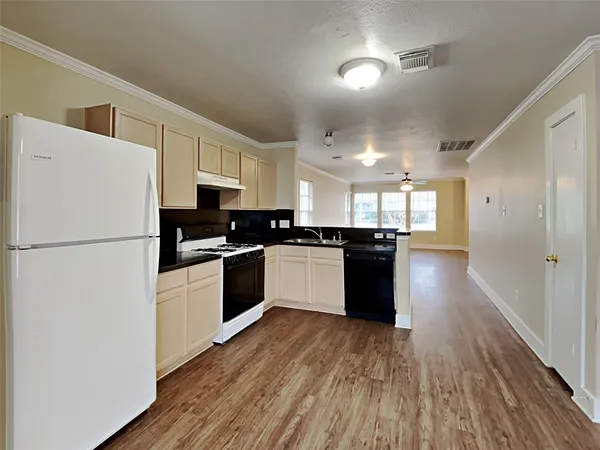 a kitchen with granite countertop a refrigerator and a stove