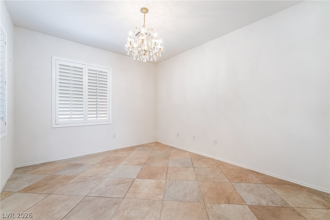3033 Hartsville Road Henderson, NV 89052 - Photo 11 of 41 Ornate crystal chandelier and crisp white window shutters elevate this versatile room.