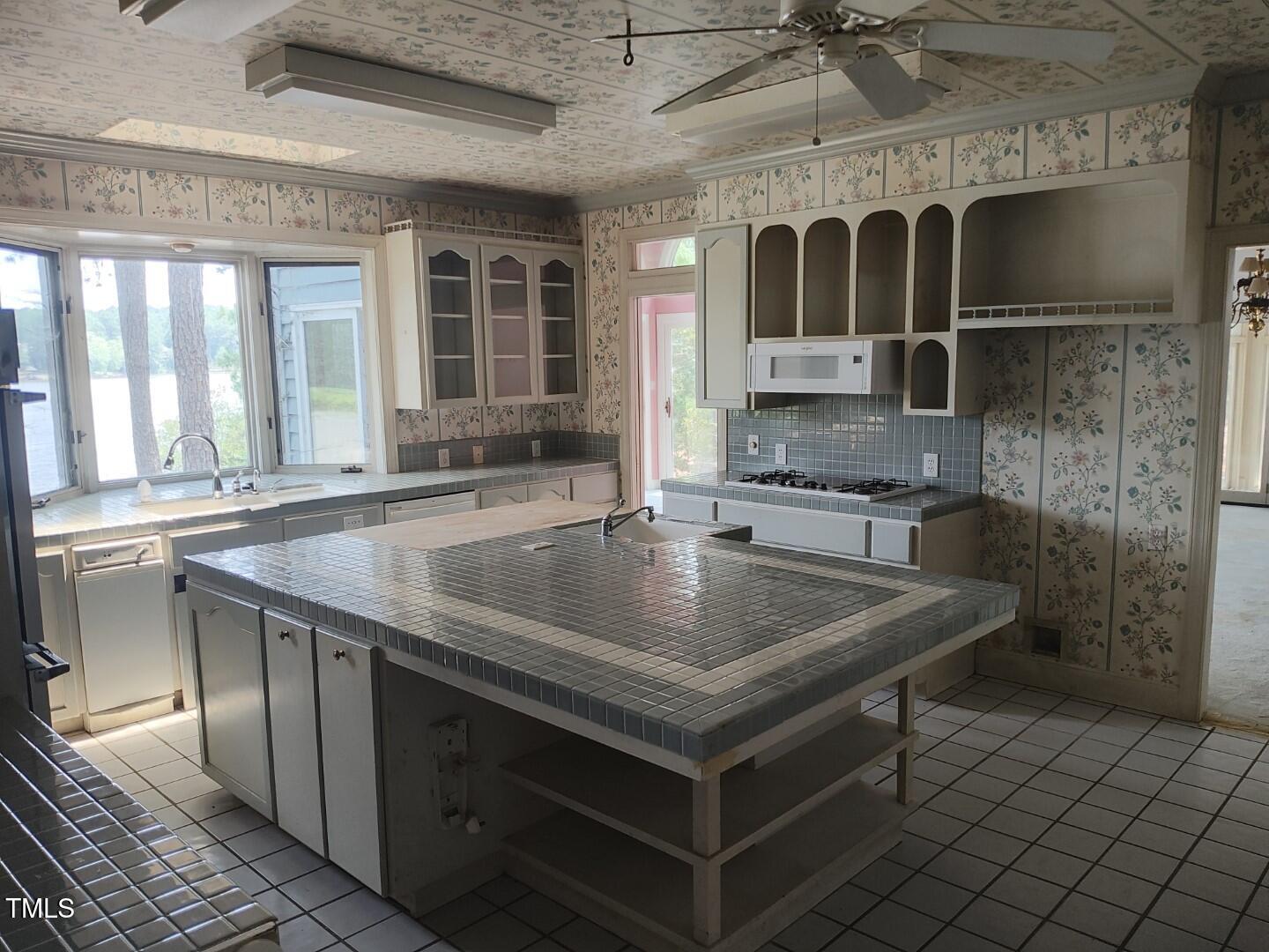 11 Abington Drive Pinehurst, NC 28374 - Photo 16 of 32 a kitchen with a sink a stove and cabinets