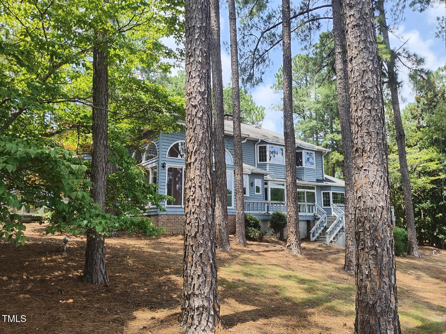 11 Abington Drive Pinehurst, NC 28374 - Photo 4 of 32 a view of a yard with plants and trees beside of it