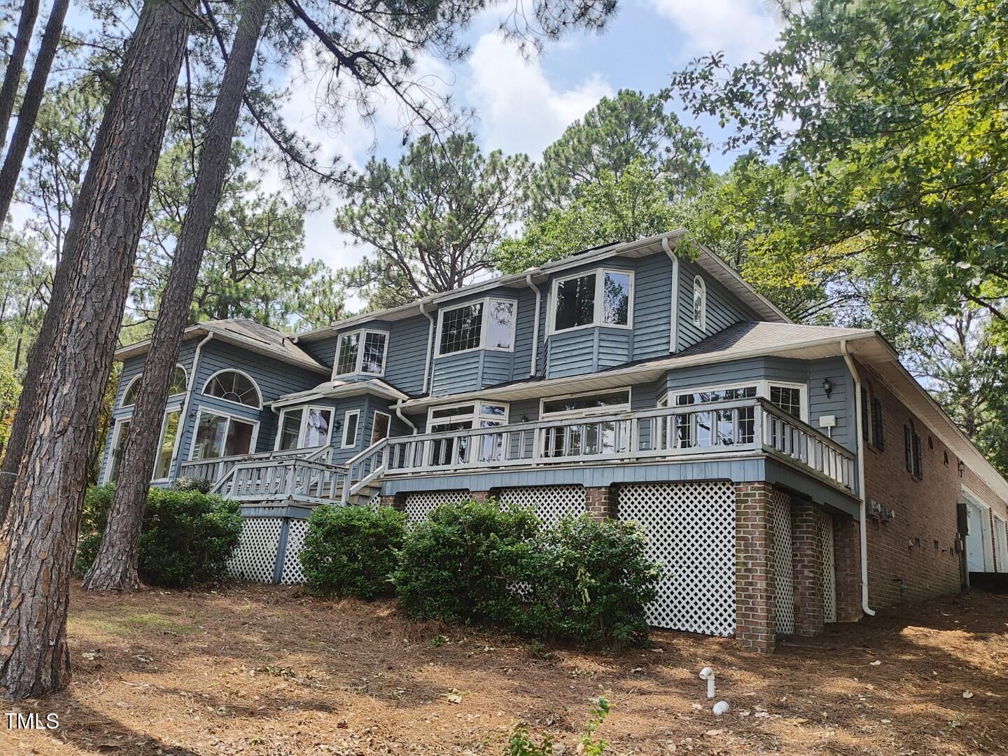 11 Abington Drive Pinehurst, NC 28374 - Photo 6 of 32 a view of a house with a yard and plants