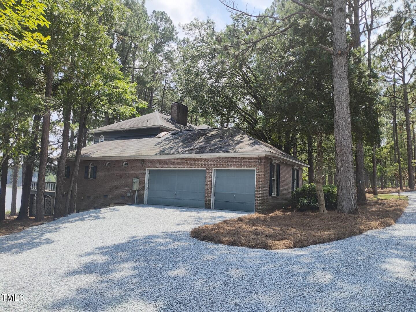 11 Abington Drive Pinehurst, NC 28374 - Photo 7 of 32 a front view of a house with a yard and garage