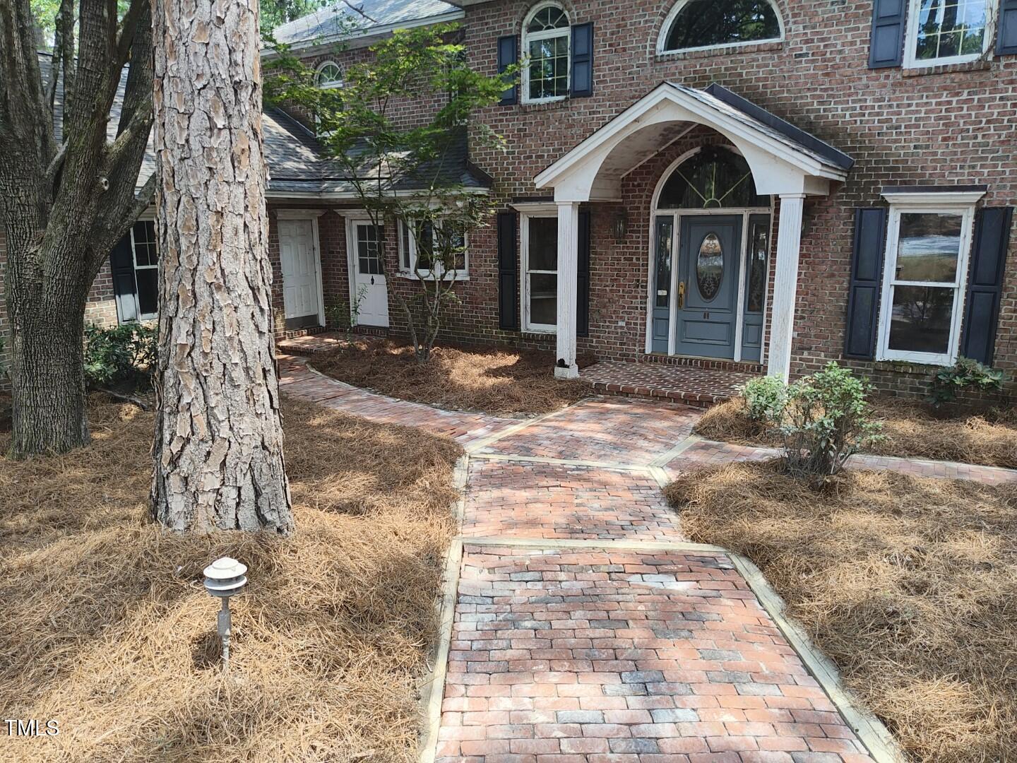 11 Abington Drive Pinehurst, NC 28374 - Photo 8 of 32 a view of a brick house with many windows