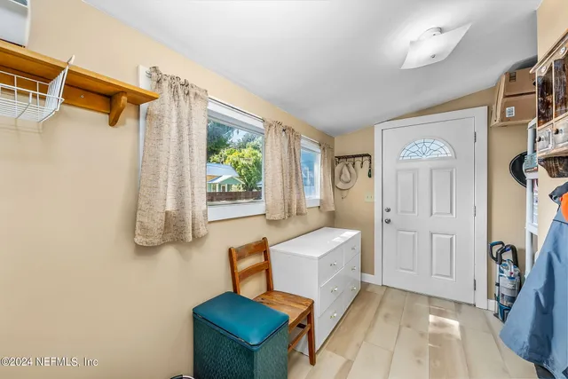 a spacious bedroom with a bed and a window