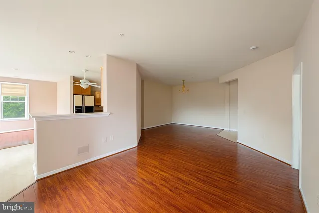 a view of a room with wooden floor and a window