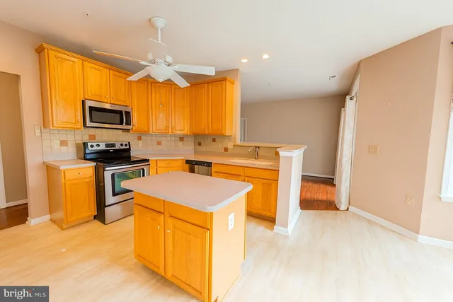 a kitchen with a stove a sink and a refrigerator