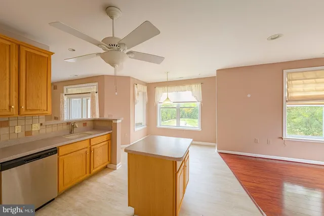 a large white kitchen with a large window