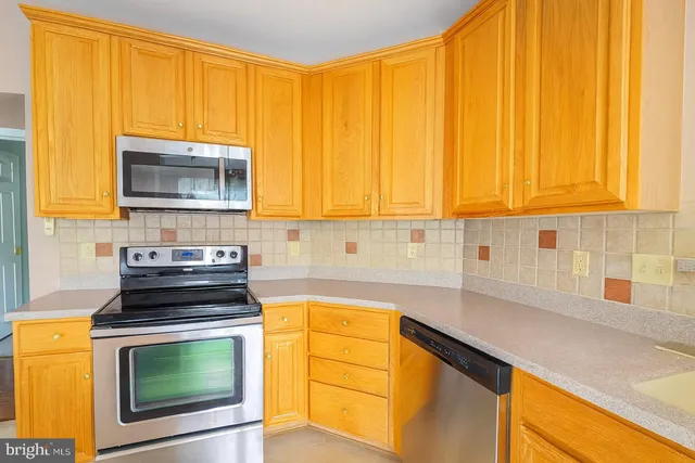 a kitchen with wooden cabinets and a stove top oven