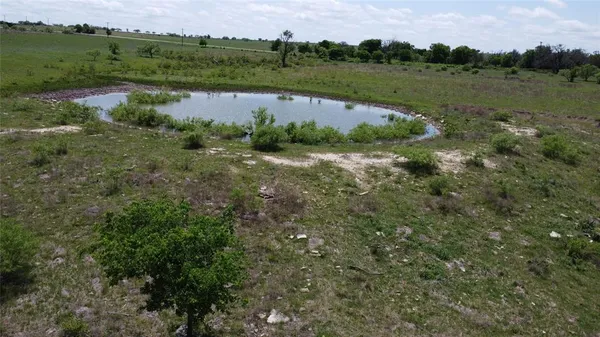 an aerial view of a houses with outdoor space and lake view