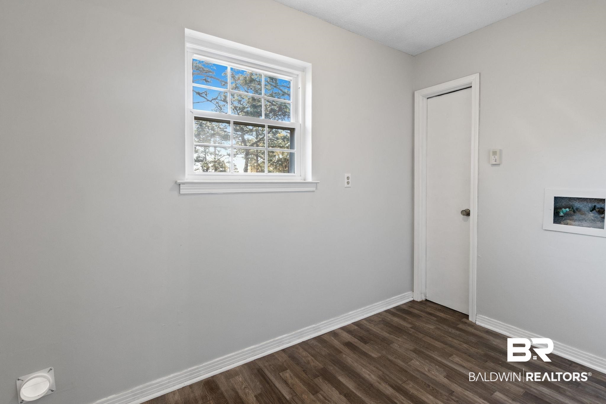 3864 Leroy Stevens Road Mobile, AL 36619 - Photo 26 of 33 Spare room featuring baseboards and dark wood-type flooring