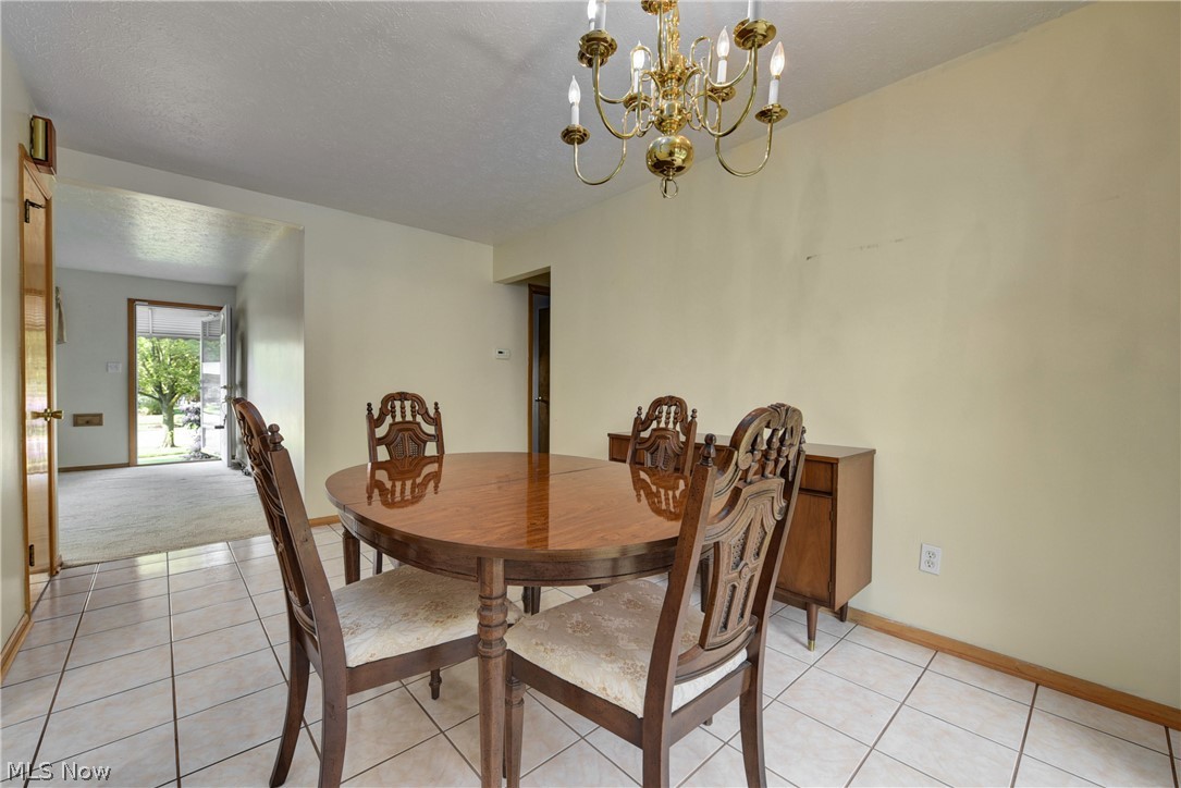 13617 Sheldon Road Cleveland, OH 44130 - Photo 10 of 36 Tiled dining area featuring a notable chandelier