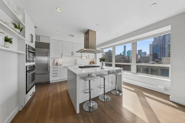 a kitchen with stainless steel appliances a stove a sink and a refrigerator