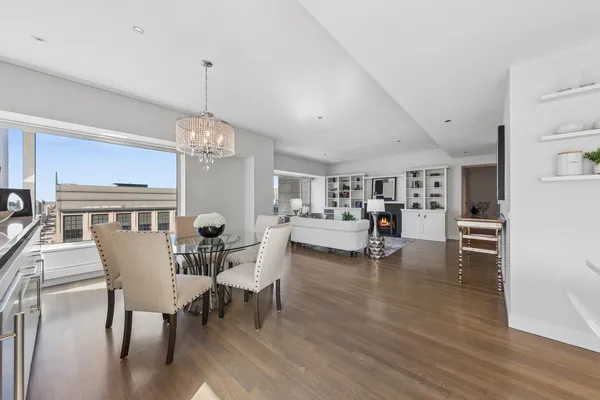 a view of a dining room with furniture wooden floor and chandelier