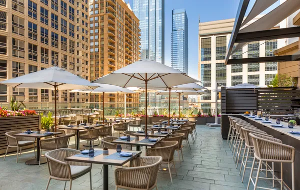 an outdoor space with patio and white umbrellas