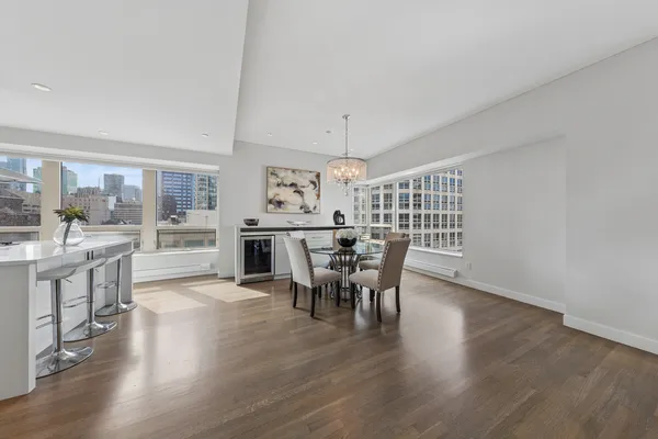 a dining room with furniture and wooden floor