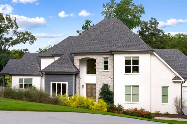 a living room with furniture and floor to ceiling windows