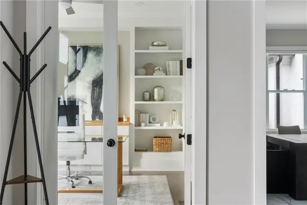 a living room with a bed furniture and a window