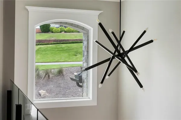 a bedroom with a bed and a lamp on dresser