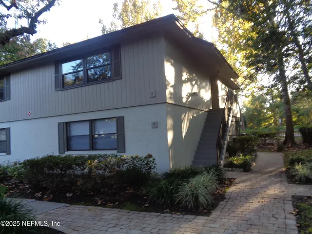 a front view of house along with green space