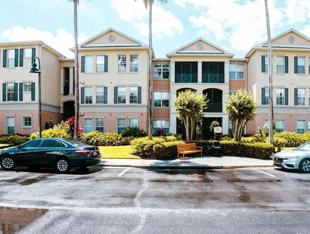 a front view of a house with cars parked