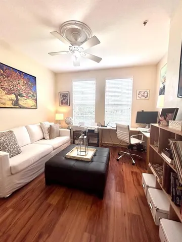 a living room with furniture or couch and a large window