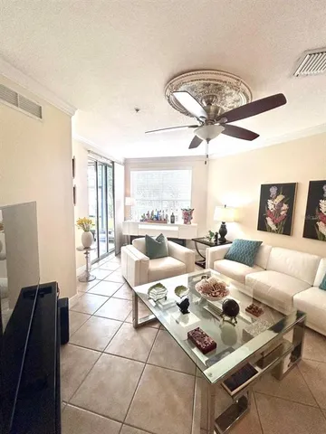 a living room with lots of furniture and a large window