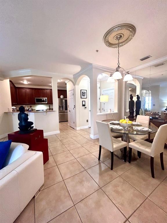 8168 Boat Hook Loop, Unit 107 Windermere, FL 34786 - Photo 17 of 25 a living room with furniture a chandelier and a dining table