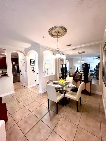 a living room with lots of furniture and view of kitchen
