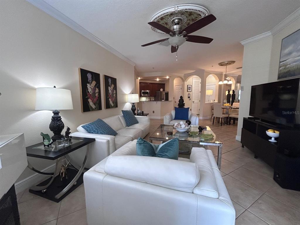 8168 Boat Hook Loop, Unit 107 Windermere, FL 34786 - Photo 20 of 25 a living room with furniture and a flat screen tv