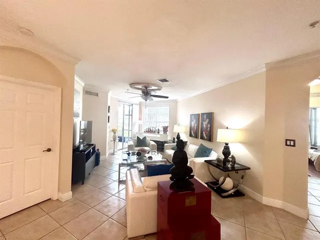 a living room with a large window and furniture