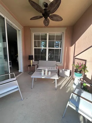 a living room with fireplace furniture and a large window