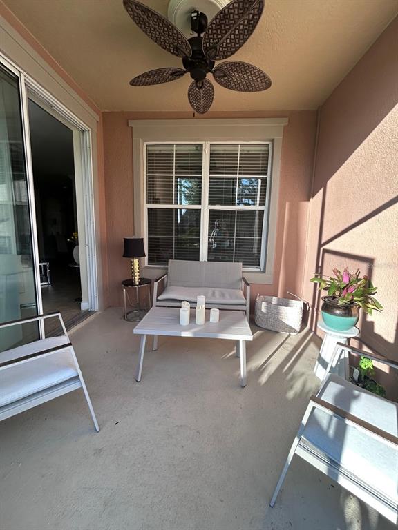 8168 Boat Hook Loop, Unit 107 Windermere, FL 34786 - Photo 24 of 25 a living room with a large window and furniture