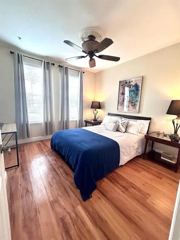 a bedroom with a large bed and a large window