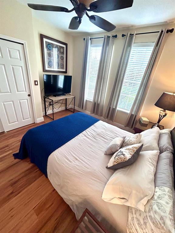 8168 Boat Hook Loop, Unit 107 Windermere, FL 34786 - Photo 4 of 25 a bedroom with a bed and wooden floor