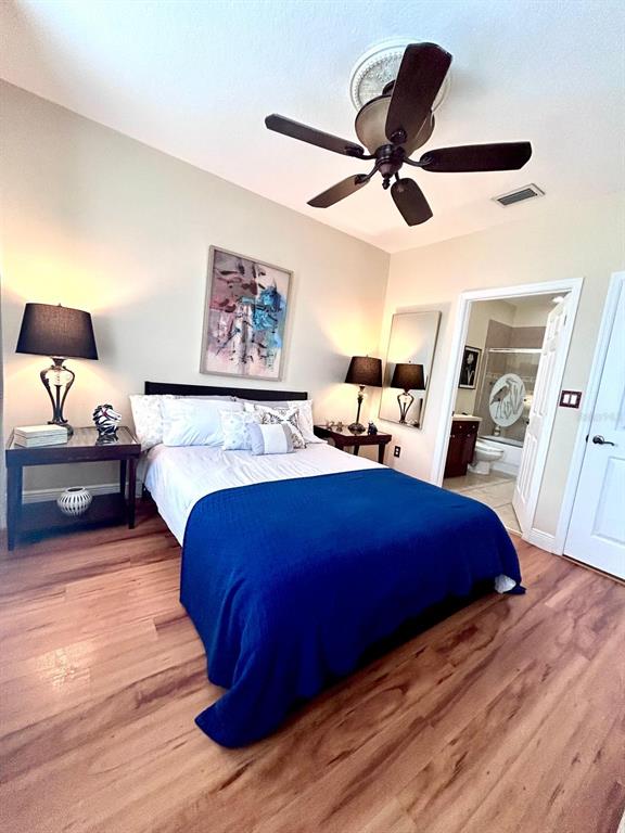 8168 Boat Hook Loop, Unit 107 Windermere, FL 34786 - Photo 7 of 25 a bed room with a bed and a ceiling fan