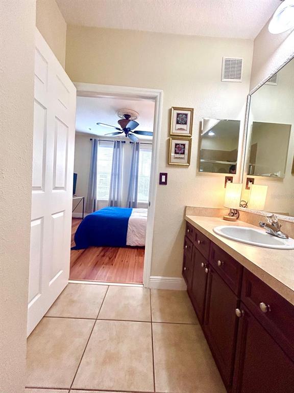 8168 Boat Hook Loop, Unit 107 Windermere, FL 34786 - Photo 9 of 25 a bathroom with a sink a mirror and a toilet