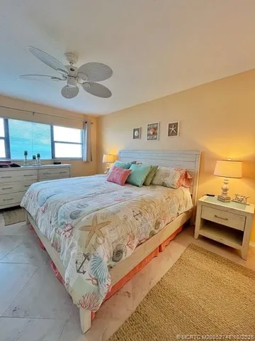 a bedroom with a bed and ceiling fan