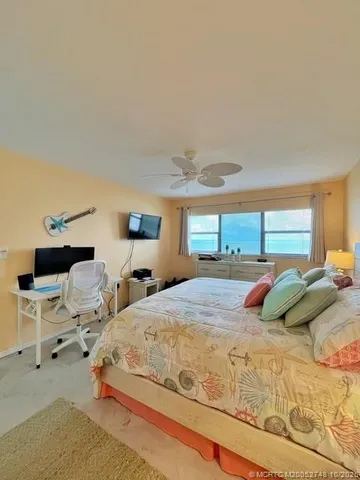 a bedroom with a large bed and window