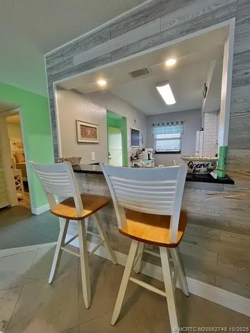 a view of a room with furniture and wooden floor