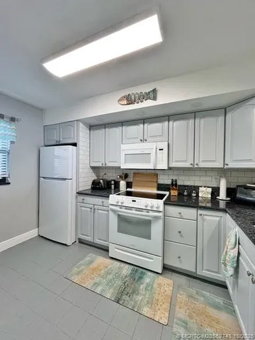a kitchen with a white cabinets and white appliances