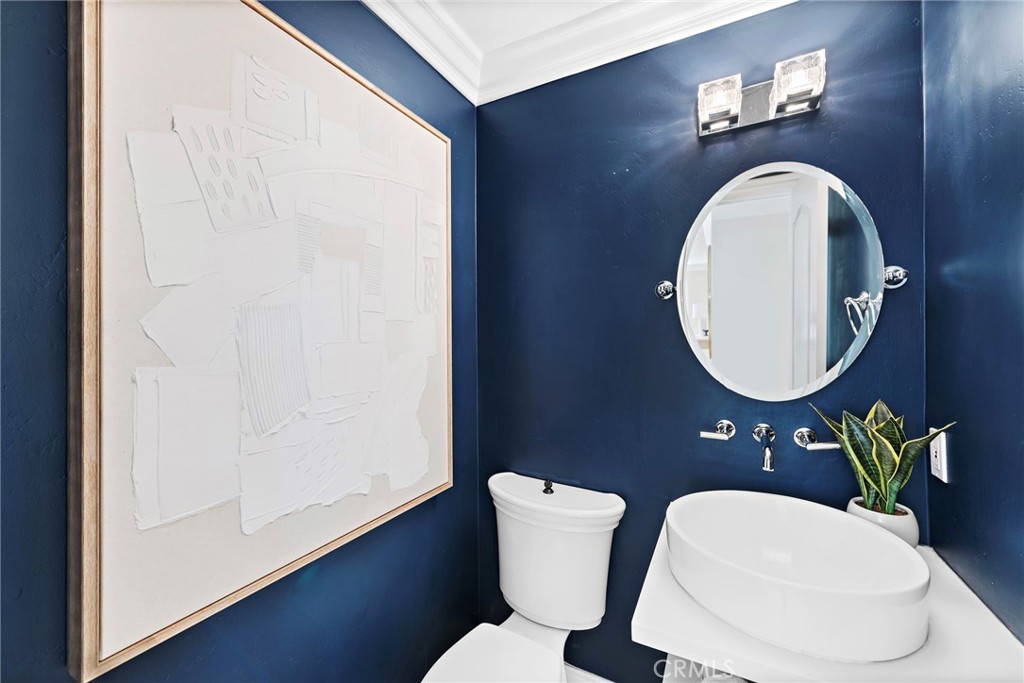 20 Regina Dana Point, CA 92629 - Photo 15 of 26 a bathroom with a toilet a sink and mirror