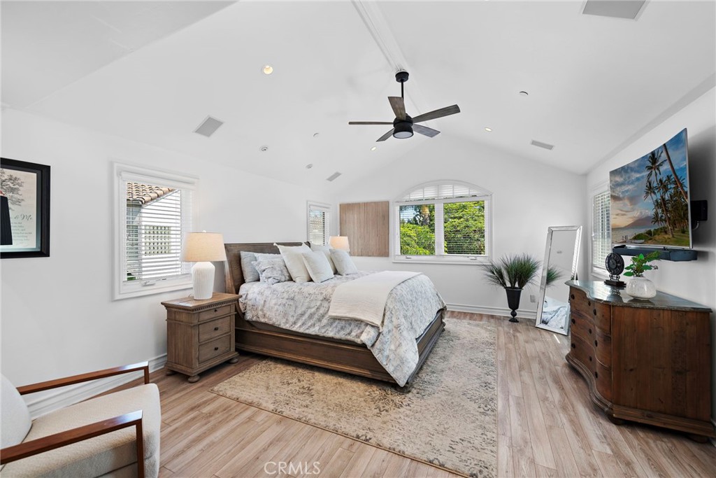 20 Regina Dana Point, CA 92629 - Photo 16 of 26 a spacious bedroom with a bed a couch and a flat screen tv